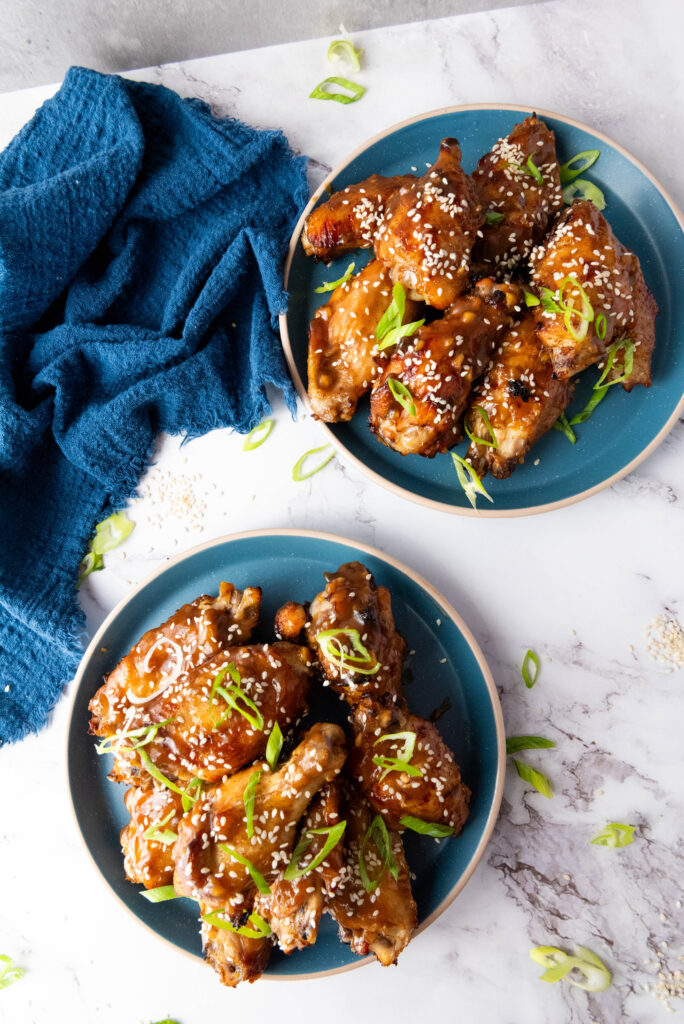Two plates of asian sticky wings